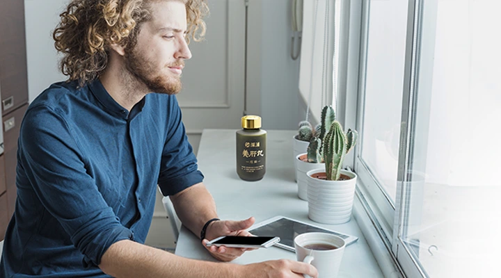 A man is looking at window, SP Pro-Liver Pills is near by him.
